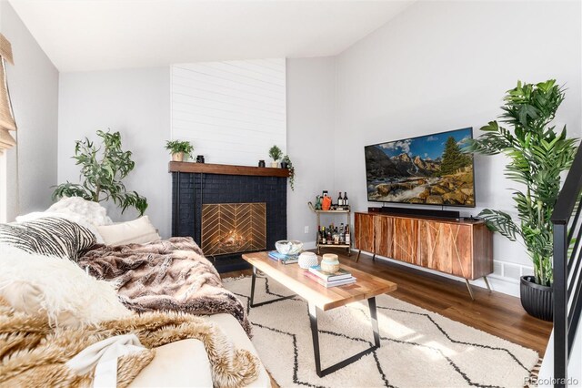4800 S Tabor St, Morrison, CO 80465 - living room featuring a brick fireplace and wood finished floors