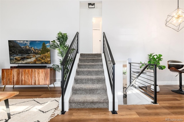 4800 S Tabor St, Morrison, CO 80465 - staircase featuring wood finished floors and baseboards