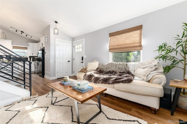 4800 S Tabor St, Morrison, CO 80465 - living area featuring lofted ceiling, light wood-type flooring, and stairway