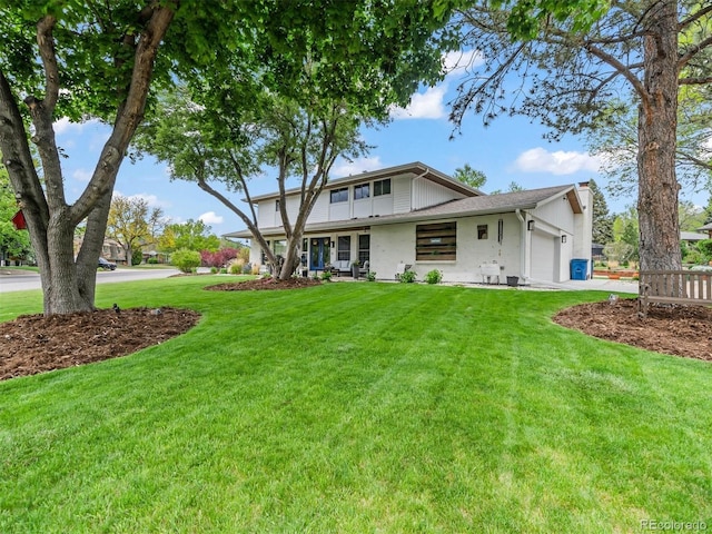 6111 W Fremont Dr, Littleton, CO 80128 - back of property featuring an attached garage, a yard, driveway, and stucco siding