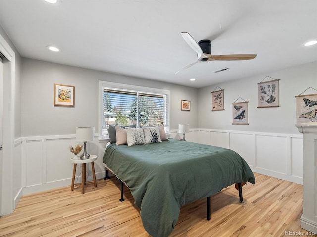 6111 W Fremont Dr, Littleton, CO 80128 - bedroom with a decorative wall, wainscoting, light wood finished floors, ceiling fan, and recessed lighting