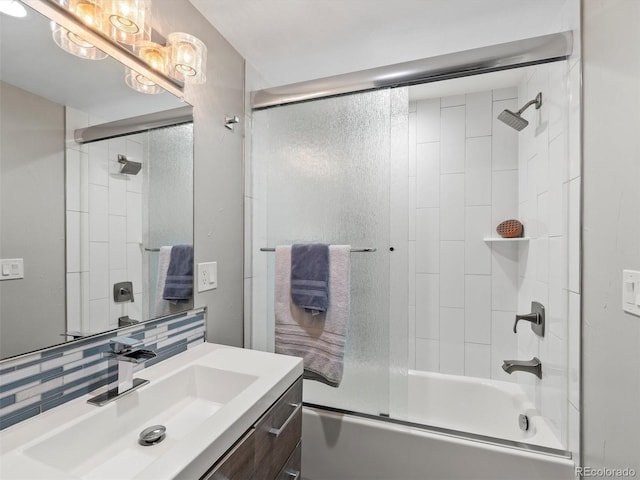 6111 W Fremont Dr, Littleton, CO 80128 - bathroom featuring vanity, combined bath / shower with glass door, and decorative backsplash