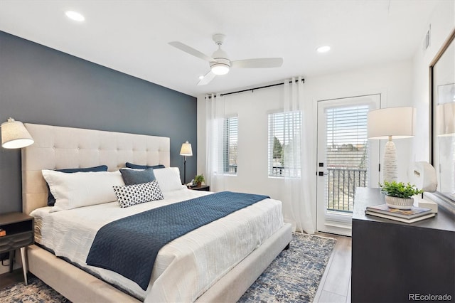 5128 W 26th Ave Unit 312, Denver, CO 80212 - bedroom with multiple windows, access to exterior, recessed lighting, a ceiling fan, and wood finished floors