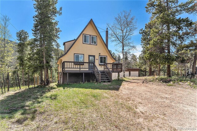 9185 Jill Dr, Conifer, CO 80433 - back of house with a wooden deck, a lawn, stairway, and a garage