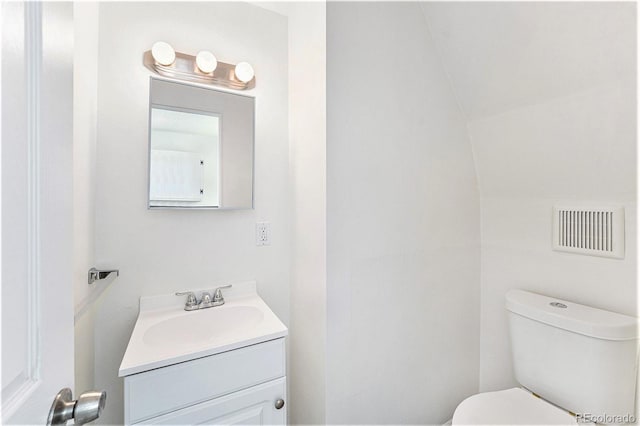 9185 Jill Dr, Conifer, CO 80433 - half bathroom with toilet, vanity, and vaulted ceiling