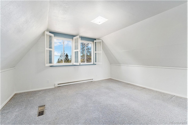 9185 Jill Dr, Conifer, CO 80433 - bonus room featuring baseboard heating, carpet floors, baseboards, vaulted ceiling, and a textured ceiling