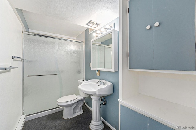 9185 Jill Dr, Conifer, CO 80433 - full bath featuring a stall shower, baseboard heating, baseboards, toilet, and a textured ceiling