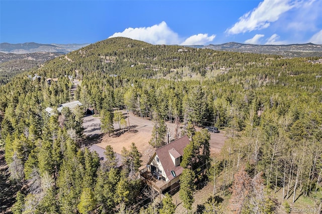 9185 Jill Dr, Conifer, CO 80433 - view of subject property featuring a heavily wooded area and a mountainous background