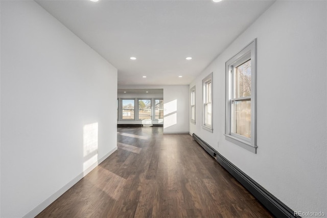 hall with dark hardwood / wood-style floors and baseboard heating