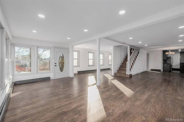 entrance foyer with dark hardwood / wood-style flooring, a chandelier, and a baseboard heating unit