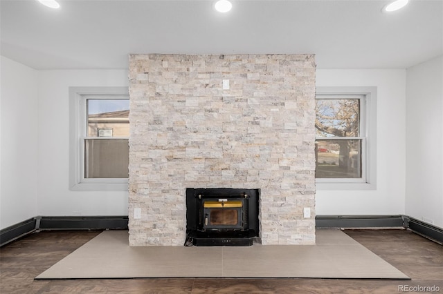 interior details with wood-type flooring and a wood stove