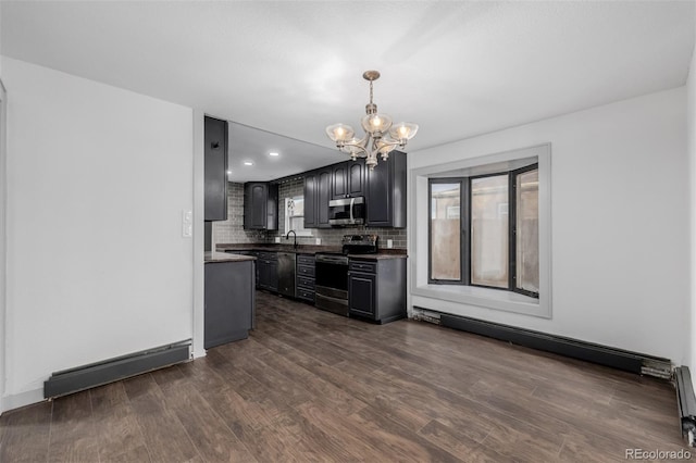 kitchen featuring stainless steel appliances, tasteful backsplash, baseboard heating, dark hardwood / wood-style flooring, and a chandelier