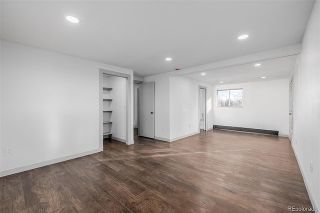 interior space with dark hardwood / wood-style floors and baseboard heating