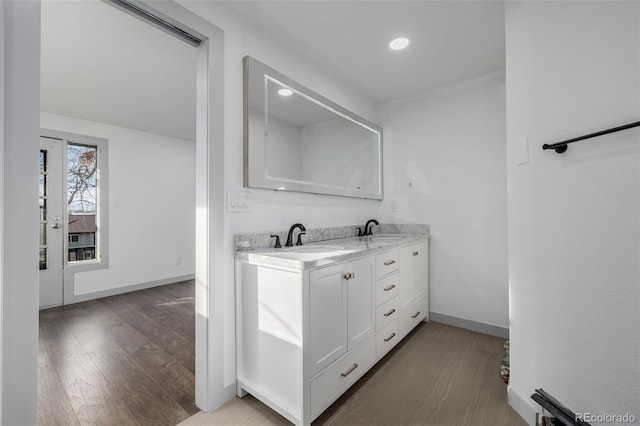 bathroom with hardwood / wood-style flooring and vanity