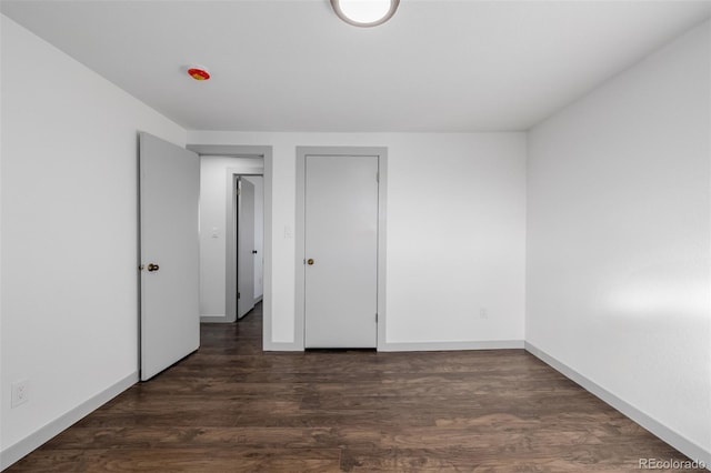 unfurnished bedroom featuring dark wood-type flooring