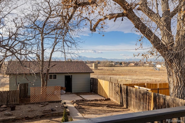 exterior space with a mountain view, a rural view, and an outdoor structure