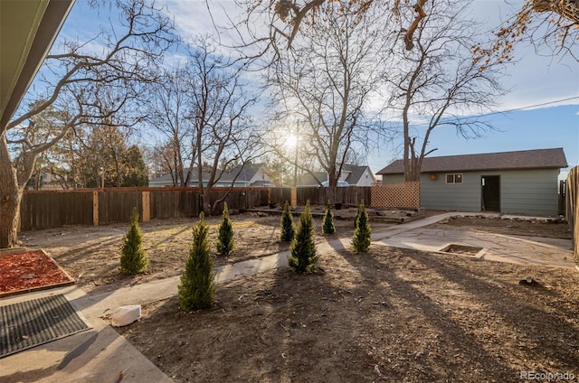 view of yard with an outbuilding and a patio