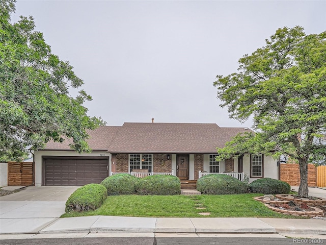 3265 W 11th Avenue Ct, Broomfield, CO 80020 - view of front of property featuring an attached garage, concrete driveway, covered porch, roof with shingles, and brick siding