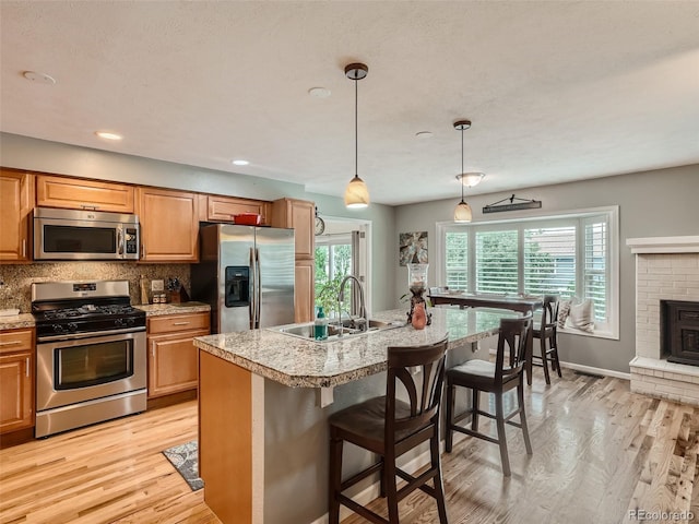 3265 W 11th Avenue Ct, Broomfield, CO 80020 - kitchen featuring stainless steel appliances, a sink, light wood-type flooring, light countertops, and recessed lighting