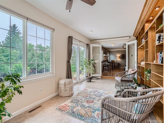 3265 W 11th Avenue Ct, Broomfield, CO 80020 - living area with healthy amount of natural light, a ceiling fan, and baseboards