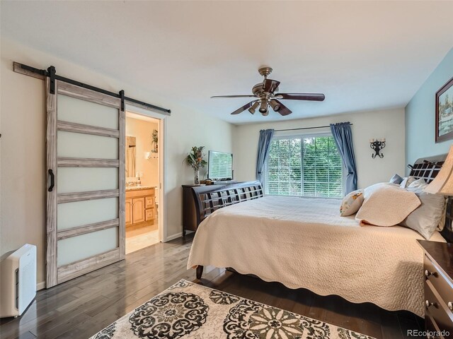 3265 W 11th Avenue Ct, Broomfield, CO 80020 - bedroom with wood finished floors, a barn door, a ceiling fan, ensuite bath, and baseboards
