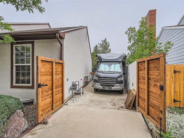 3265 W 11th Avenue Ct, Broomfield, CO 80020 - view of property exterior featuring stucco siding, a gate, and fence