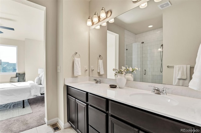 bathroom with a shower stall, visible vents, a sink, and connected bathroom