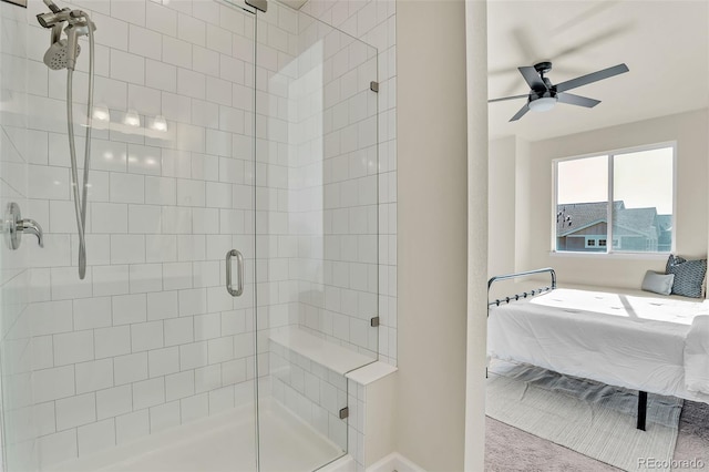 ensuite bathroom with ensuite bathroom, ceiling fan, a stall shower, and baseboards