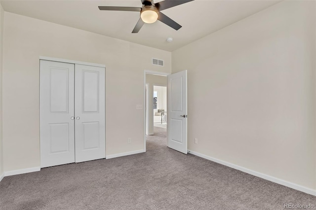 unfurnished bedroom featuring ceiling fan, carpet, a closet, visible vents, and baseboards