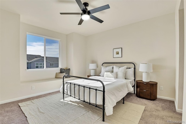 bedroom featuring baseboards, a ceiling fan, and light colored carpet