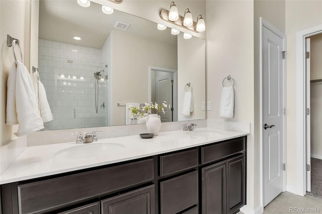bathroom with a stall shower, a sink, tile patterned flooring, and visible vents