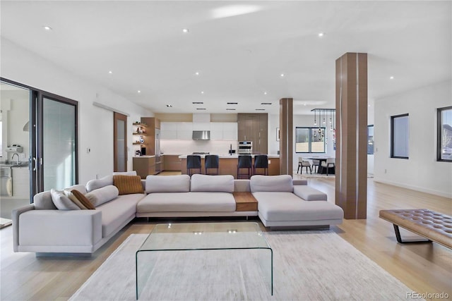 living area featuring light wood-style floors and recessed lighting
