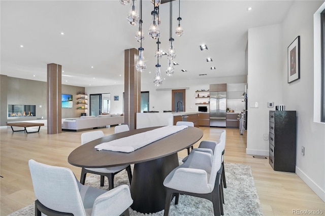 dining space featuring baseboards, recessed lighting, and light wood-type flooring