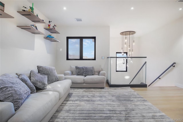 living room featuring recessed lighting, wood finished floors, and visible vents