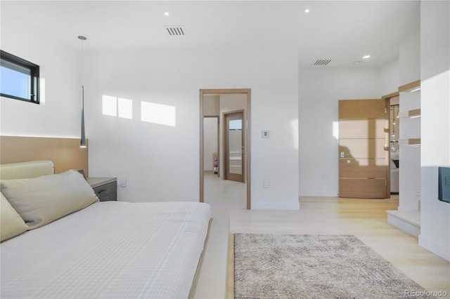 bedroom with recessed lighting, wood finished floors, and visible vents
