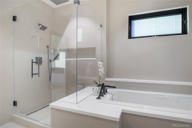 bathroom featuring a garden tub and a stall shower