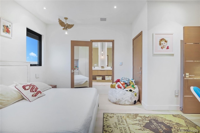 bedroom with baseboards, ensuite bathroom, and visible vents