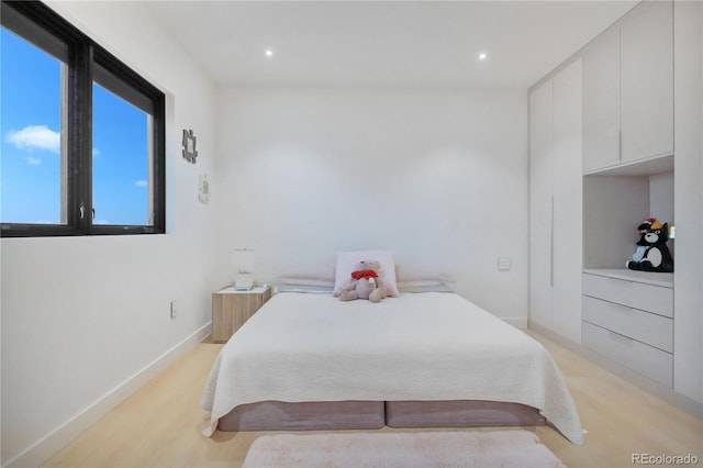 bedroom with baseboards, light wood-style floors, and recessed lighting