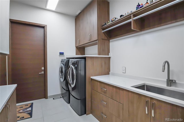 laundry room with separate washer and dryer, a sink, light tile patterned floors, and cabinet space