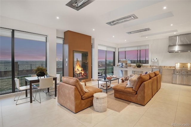 living area featuring recessed lighting, visible vents, and light tile patterned floors
