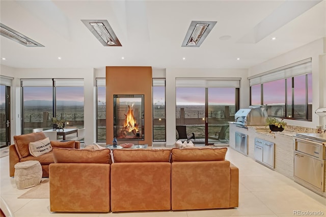 living room with recessed lighting and light tile patterned floors