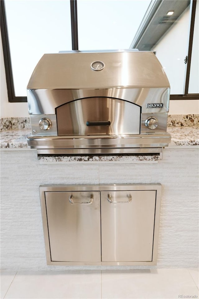 interior details with light countertops and white cabinetry