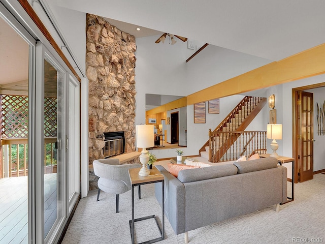 12658 W 1st Pl Unit 78, Denver, CO 80228 - living area with a stone fireplace, stairs, carpet flooring, and a towering ceiling