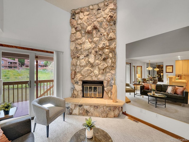 12658 W 1st Pl Unit 78, Denver, CO 80228 - carpeted living area featuring a towering ceiling, healthy amount of natural light, and a fireplace