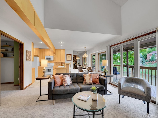 12658 W 1st Pl Unit 78, Denver, CO 80228 - living room featuring light carpet, healthy amount of natural light, a high ceiling, and recessed lighting