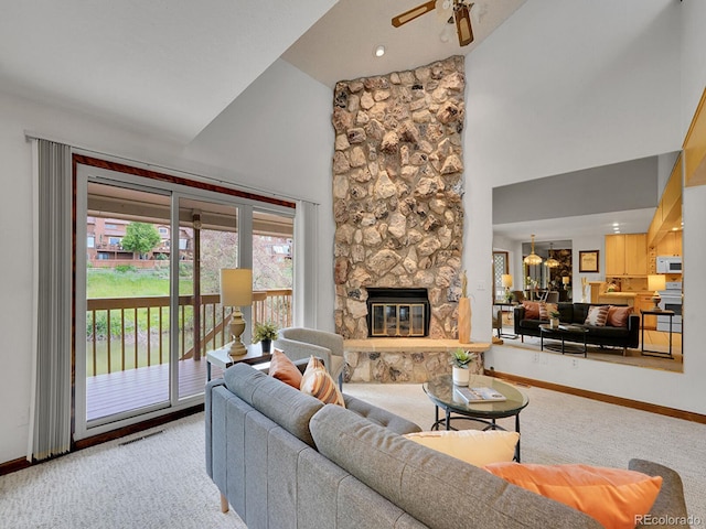 12658 W 1st Pl Unit 78, Denver, CO 80228 - carpeted living room featuring high vaulted ceiling, a stone fireplace, and ceiling fan
