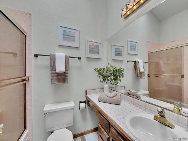 12658 W 1st Pl Unit 78, Denver, CO 80228 - full bathroom featuring vanity and bath / shower combo with glass door