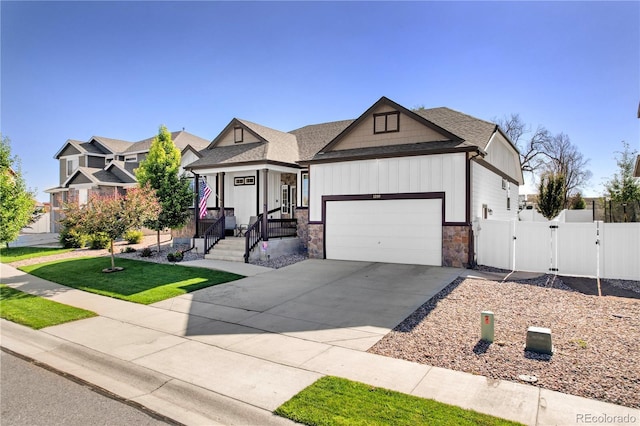 1210 Muskox St, Severance, CO 80550 - craftsman house with a gate, stone siding, a garage, driveway, and board and batten siding