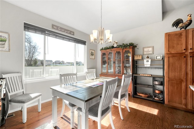 1210 Muskox St, Severance, CO 80550 - dining space with a chandelier and wood finished floors