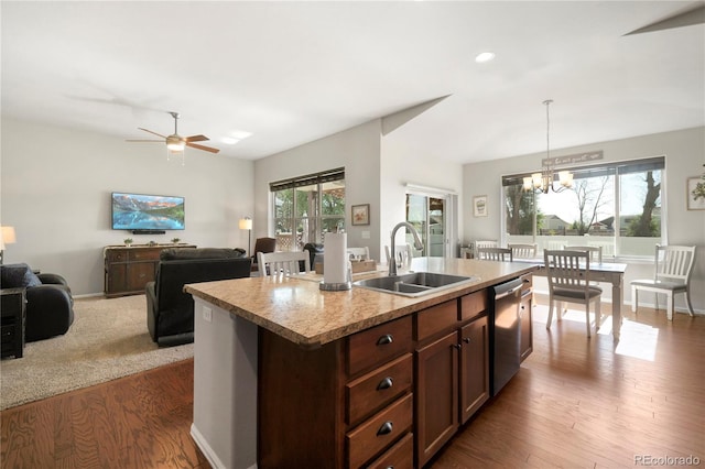 1210 Muskox St, Severance, CO 80550 - kitchen featuring stainless steel dishwasher, wood finished floors, plenty of natural light, light countertops, and recessed lighting
